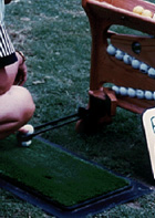 Golf ball teeing devices for use on the practice range that automatically tee up balls