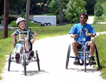 two children ride handcycles