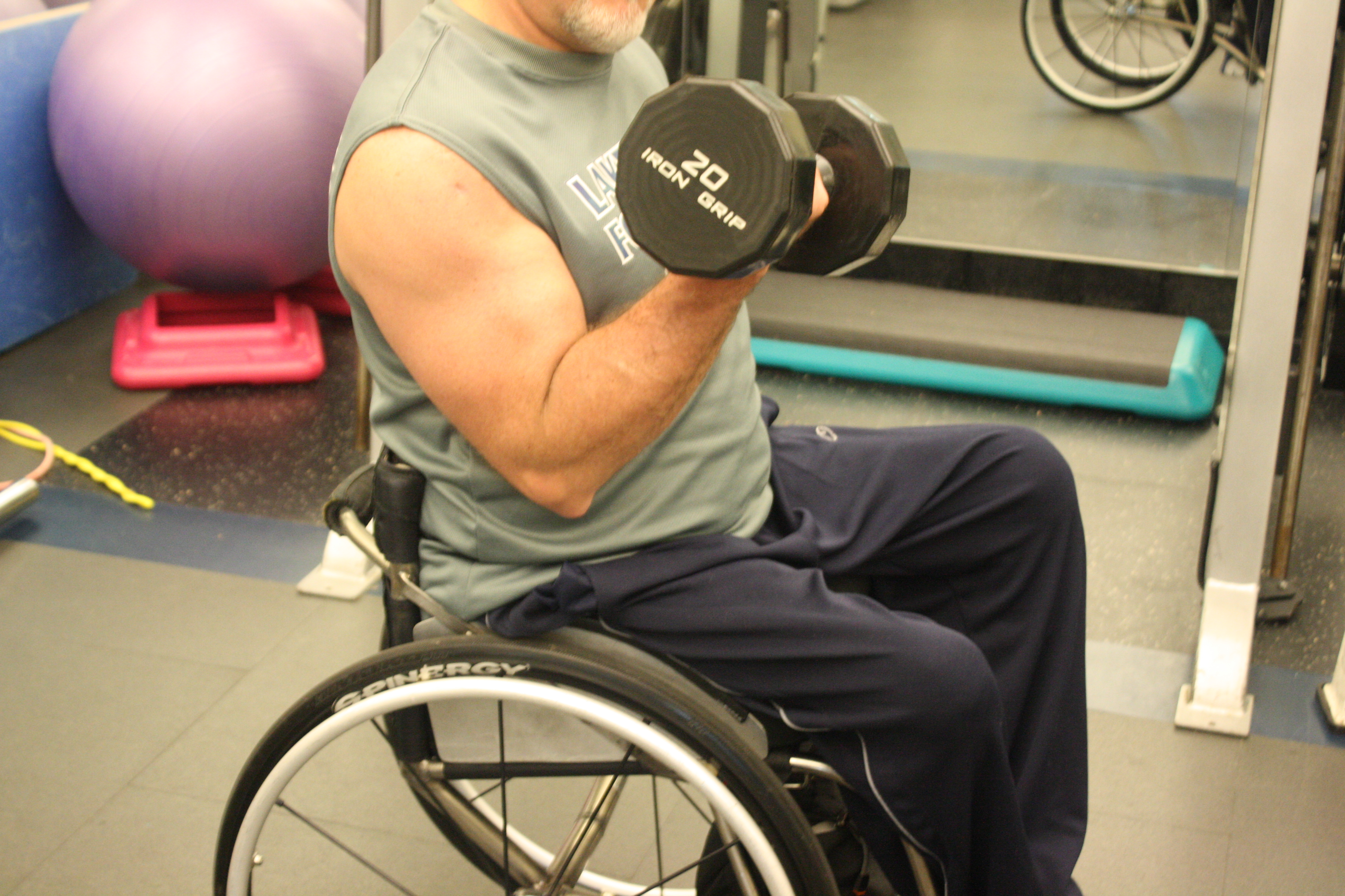 man in wheelchair doing biceps curl