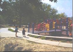 Accessible playgrounds for children with and without disabilities shows the side view of an access ramp into the playground system
