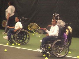 Children playing wheelchair tennis.