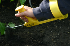 Arm shown digging dirt with a modified tool
