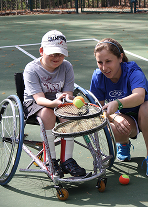 A young wheelchair tennis player and his coach