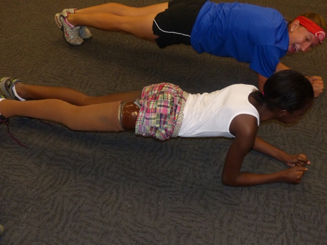 2 girls do the plank exercise