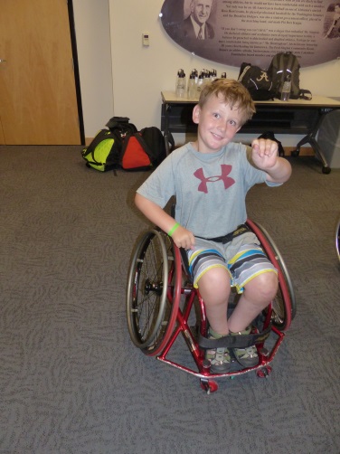 a boy in a wheelchair does punches