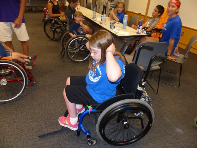 a girl does wheelchair crunches
