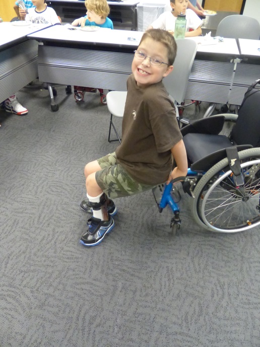 a boy uses his wheelchair to do dips