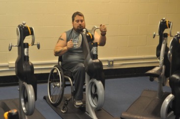 a man in a wheelchair uses a krank machine