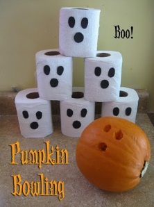 toilet paper roles and a pumpkin set up for pumpkin bowling