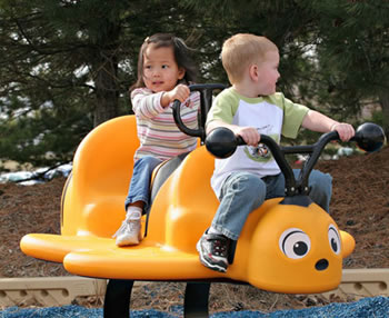 A spring rocker is molded into the shape of a yellow bumblebee with two seats on its back and a wing that is wide and deep enough for a transfer.