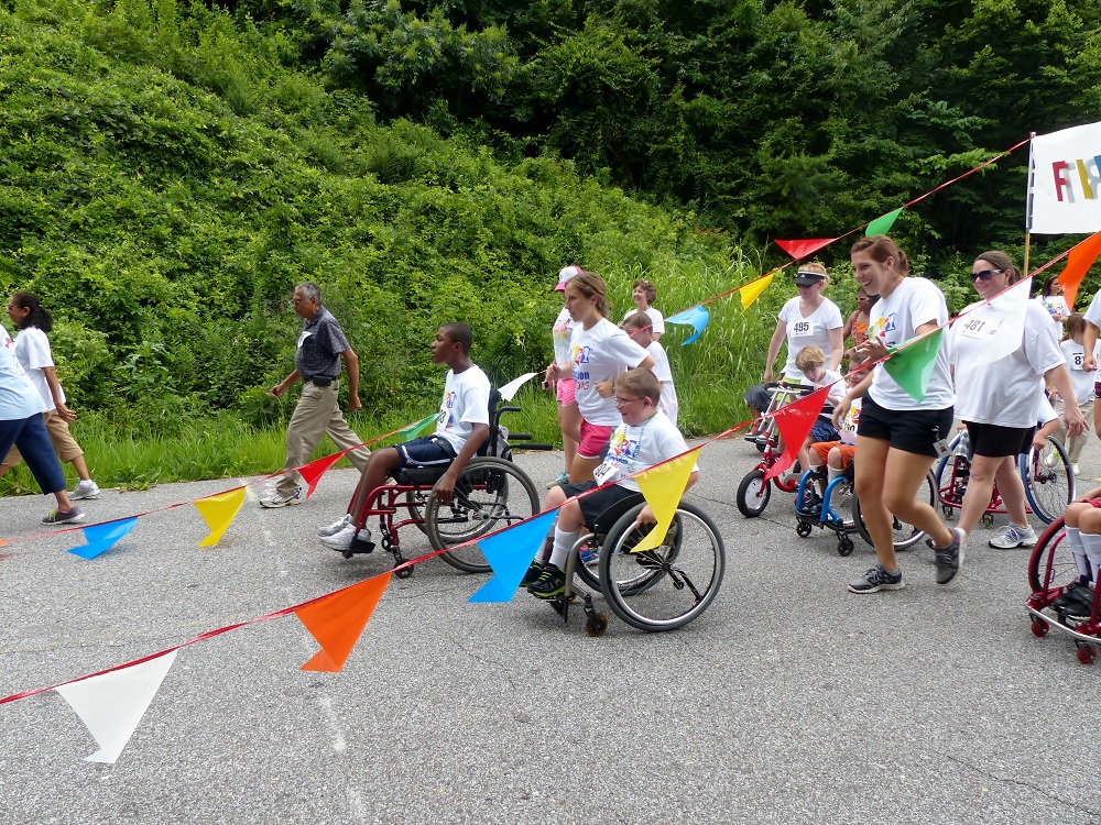 a group of people participate in a color themed run walk roll event