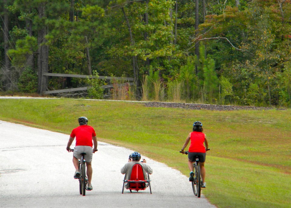 3 individuals biking together