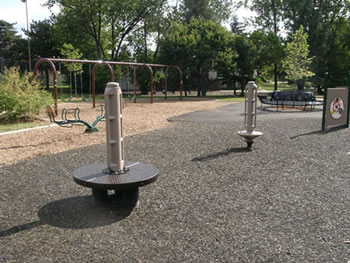Two spring poles are pictured. The one on the right has a standard base for child use. The one on the left has a wide base for use in a seated position if desired.