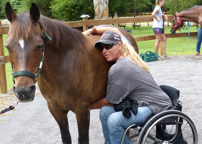 woman in a wheelchair with a horse