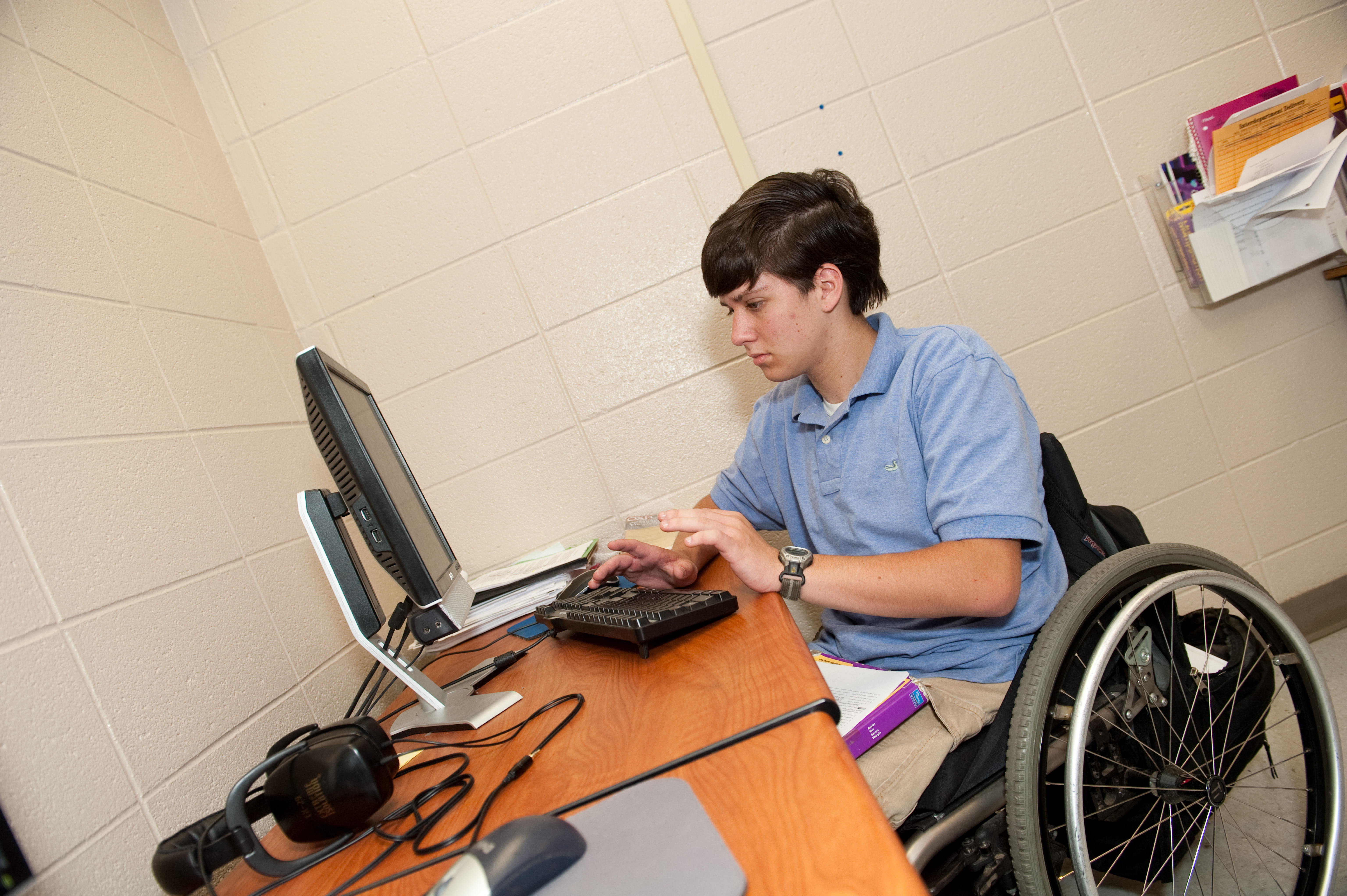 boy in wheelchair uses computer