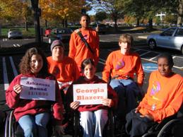 A group of youths who use wheelchairs giving their support.