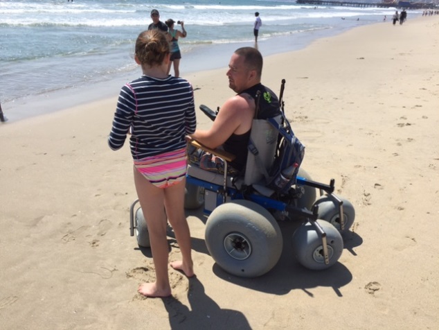 a mna uses a beach power chair