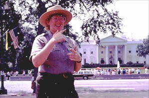 A park ranger using sign langauge in front of the White House.