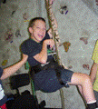 A young boy with little or no use of his legs using the Para Pull Up rock climbing technique.