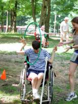 Photo of a young man doing an activity with a hoop.