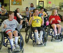 Children with a physical disability participating in an exercise class.