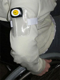 Pedometer with armband attached to the arm of a seated wheelchair user.