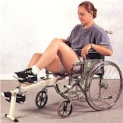 Photo of a young woman in a wheelchair using the clinical restorator with her lower body