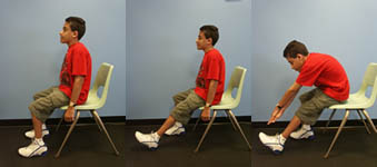 Child with Spina Bifida is performing a Hamstring Stretch from a seated position.