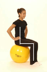 A girl demonstrating the correct position to sit on a exercise ball.