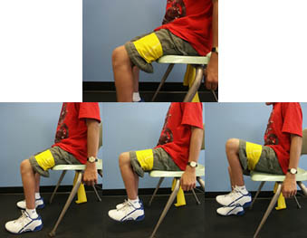 Child with Spina Bifida is performing an Hip Flexion exercise from a seated position.
