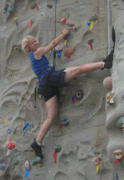 Greta Neimanas is climbing on a indoor climbing wall.