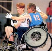 Two men playing wheelchair rugby.