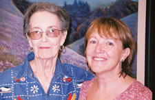 Two women smile at the camera