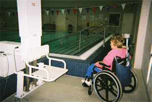 Woman in wheel chair near the swimming pool