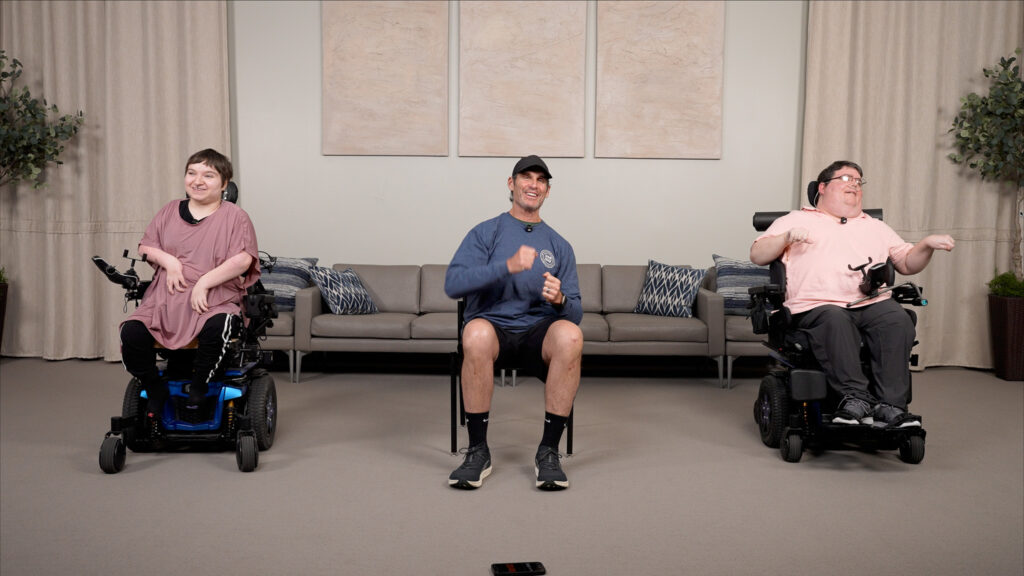 McCartney Hagar, Zach Woolley, and NCHPAD's John Reams performing cardio exercise for power wheelchair users