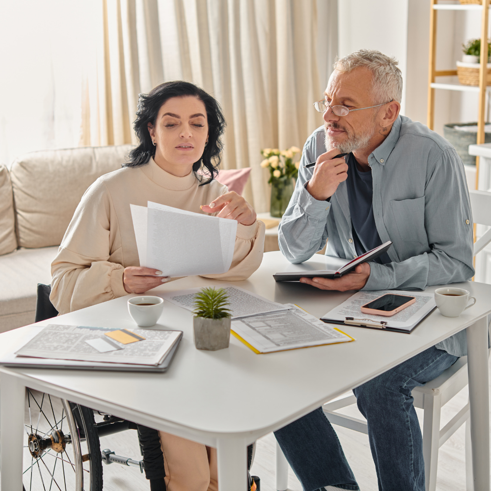 A man and a woman at a table budgeting